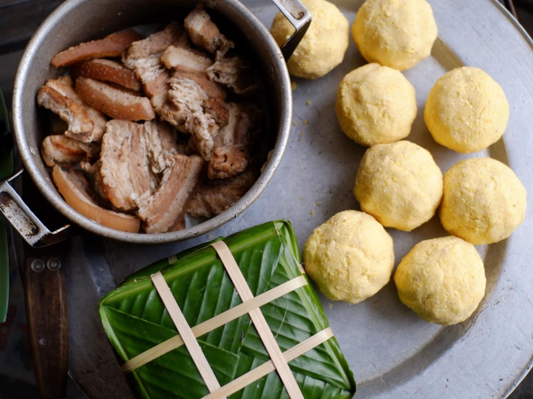 Traditional Vietnamese food prepared for travellers on tour. Travellers learn to cook sticky rice cakes - a traditional lunar new year dish in Vietnam.